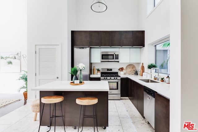 a kitchen with a table chairs stove and microwave