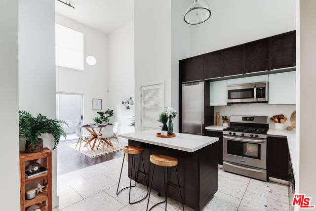 a kitchen with a sink a microwave a stove and refrigerator