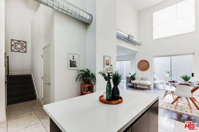 a table with potted plant and a view of living room