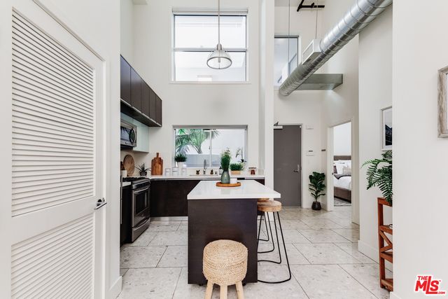 a view of a dining room with furniture and a potted plant
