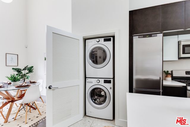 a view of a refrigerator and washer in a kitchen