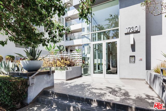 a view of a patio with couches table and chairs and potted plants