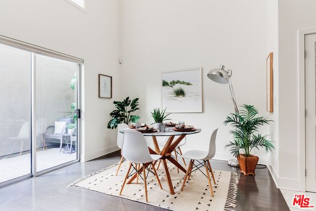 a dining room with furniture and wooden floor