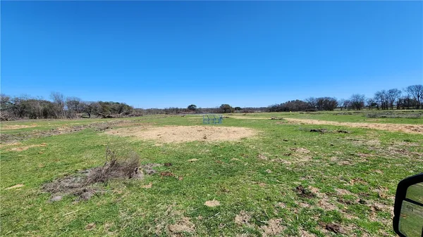 a view of a field with an ocean