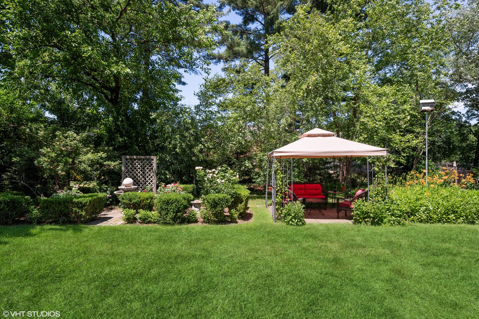 1544 Longvalley Road Glenview, IL 60025 - Photo 21 of 25 a view of a backyard with potted plants and large trees