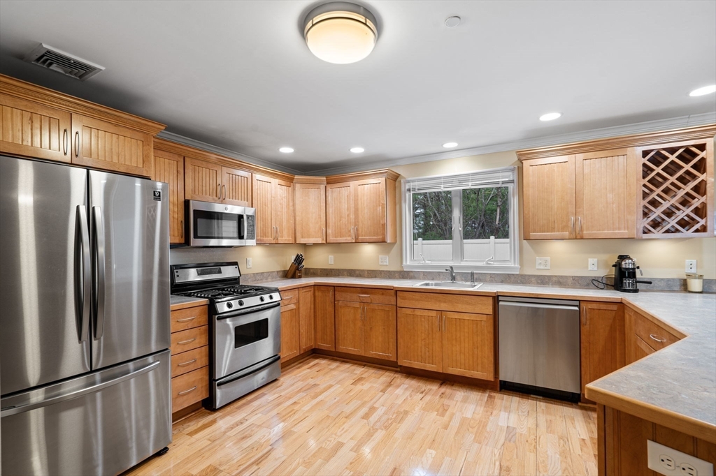 216 Rangeway Road, Unit 182 Billerica, MA 01862 - Photo 17 of 42 a kitchen with stainless steel appliances granite countertop a sink a stove a refrigerator cabinets and a window