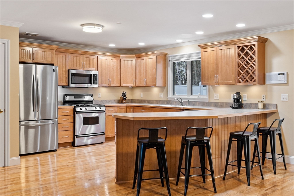 216 Rangeway Road, Unit 182 Billerica, MA 01862 - Photo 18 of 42 a kitchen with granite countertop a oven a stove a refrigerator and white cabinets