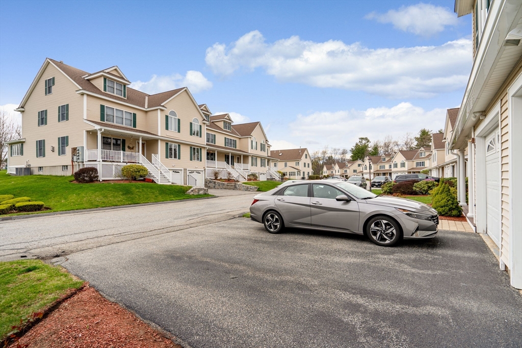 216 Rangeway Road, Unit 182 Billerica, MA 01862 - Photo 42 of 42 a car parked in front of a white house