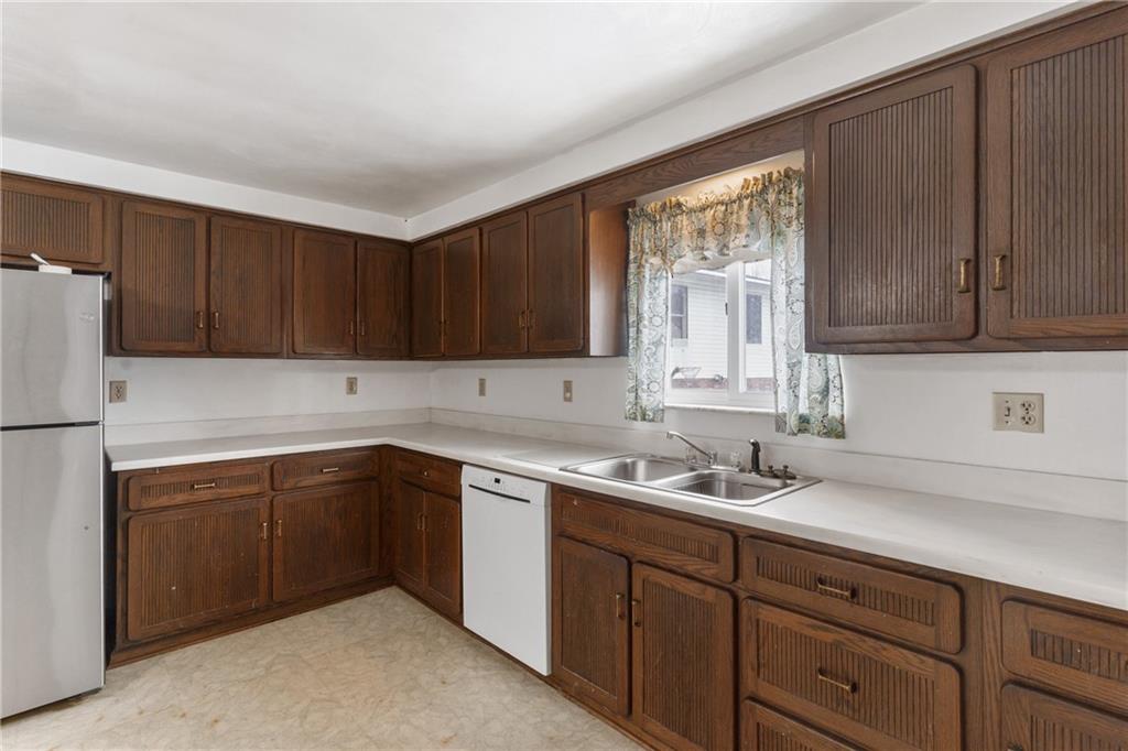 2116 Claridge Elliott Road Claridge, PA 15623 - Photo 10 of 25 a kitchen with wood cabinets sink and window