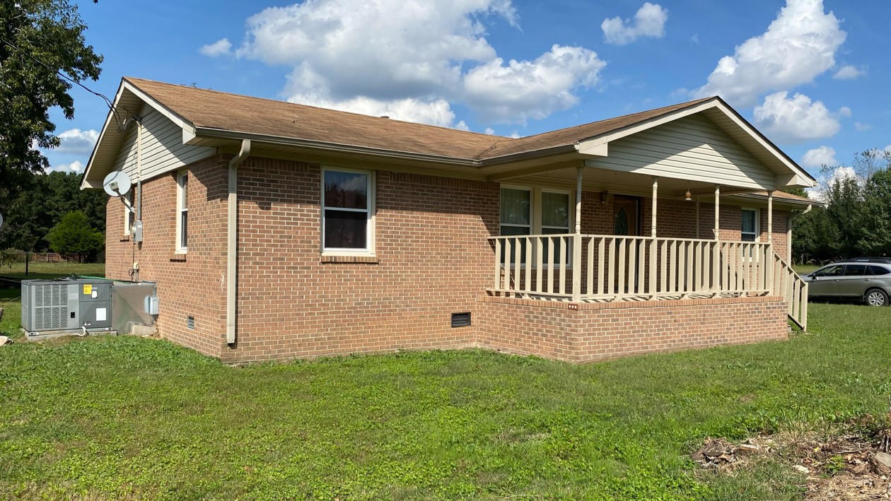 27085 Bethel Road Elkmont, AL 35620 - Photo 1 of 45 a front view of a house with garden