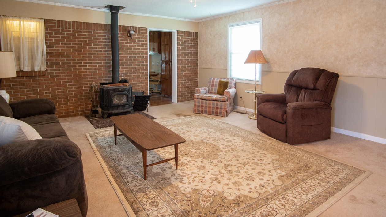 27085 Bethel Road Elkmont, AL 35620 - Photo 31 of 45 a living room with furniture and a fireplace