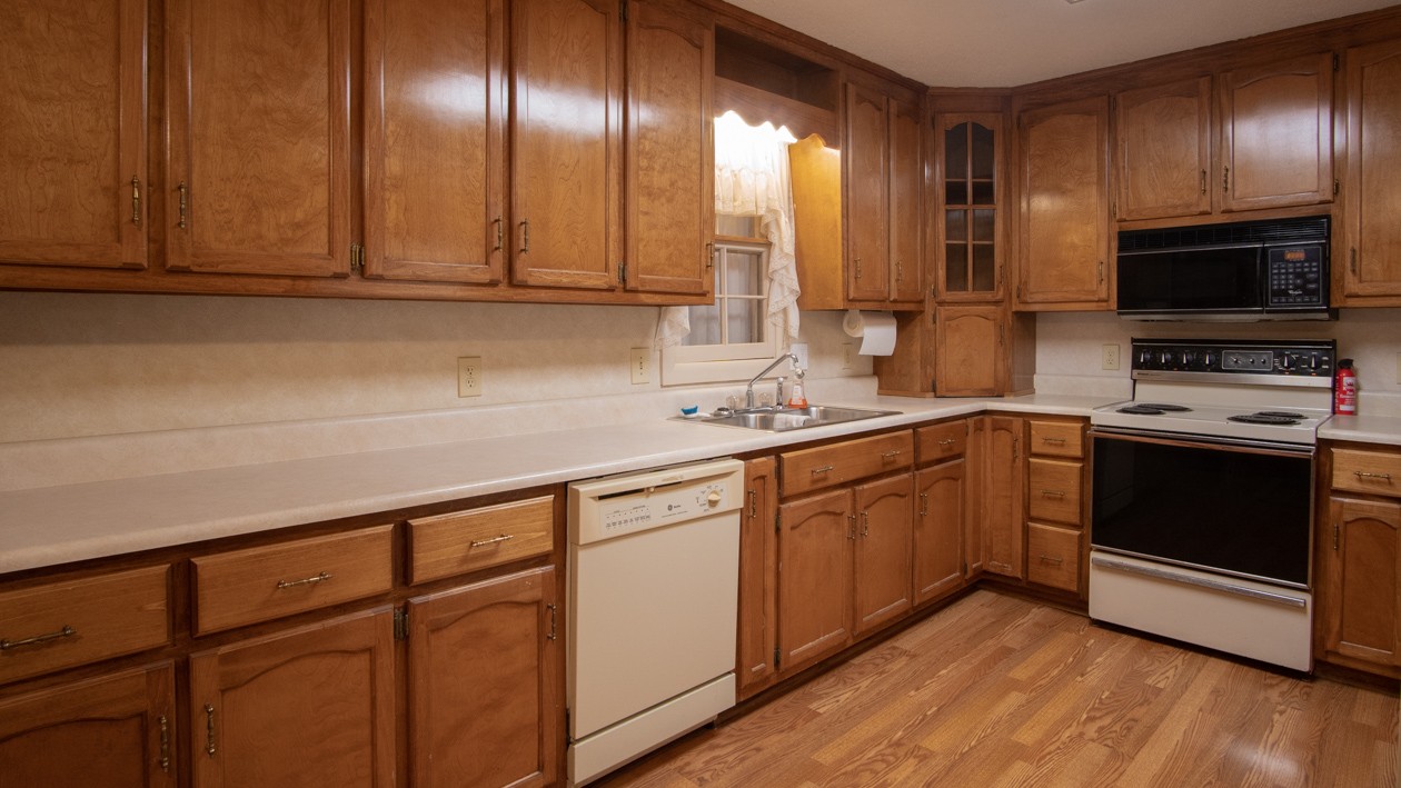 27085 Bethel Road Elkmont, AL 35620 - Photo 35 of 45 a kitchen with granite countertop stainless steel appliances a sink stove top oven and cabinets