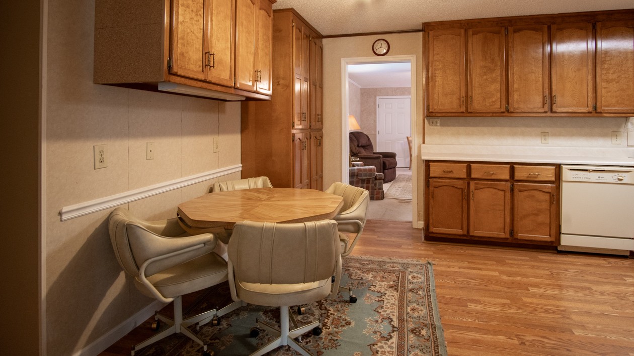 27085 Bethel Road Elkmont, AL 35620 - Photo 36 of 45 a kitchen with stainless steel appliances granite countertop a sink a stove a dining table and chairs