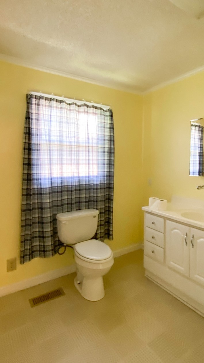 27085 Bethel Road Elkmont, AL 35620 - Photo 37 of 45 a bathroom with a granite countertop toilet a sink and a shower