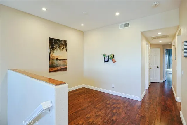 a view of hallway with wooden floor