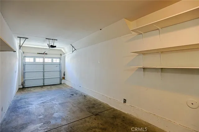 a view of a patio with table and chairs under an umbrella