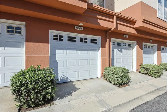 a swimming pool with outdoor seating and palm trees