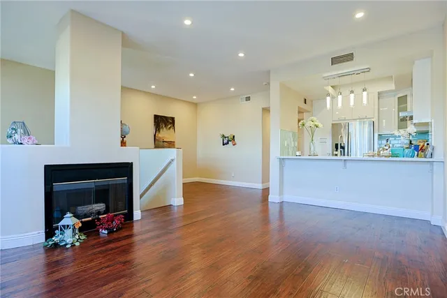 a view of a living room kitchen and a wooden floor