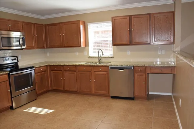 a kitchen with a sink stove top oven and cabinets