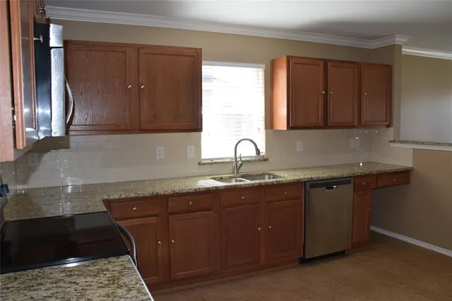 a kitchen with a sink and cabinets