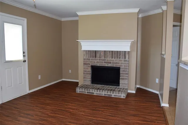 a view of a livingroom with a fireplace a fireplace and wooden floor