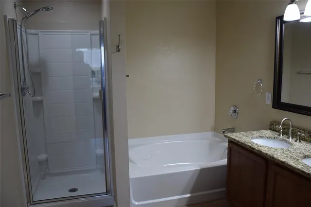 a white bath tub sitting next to a bathroom sink