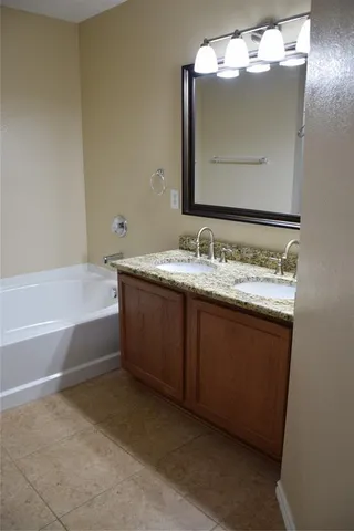 a bathroom with a sink vanity and mirror