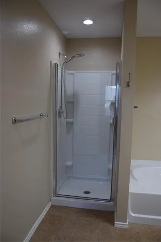 a bathroom with a glass shower door