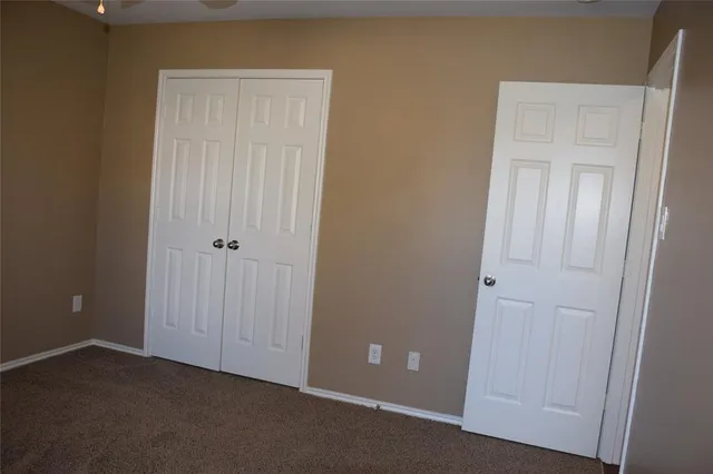 an empty room with a ceiling fan