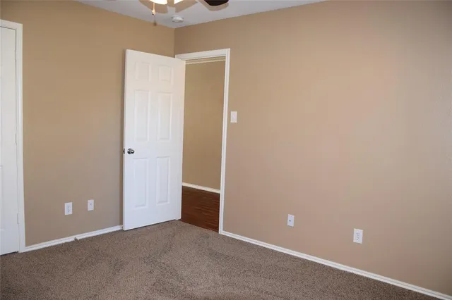 a view of a backyard with wooden fence