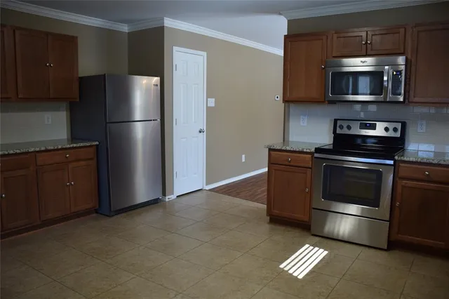 a kitchen with a refrigerator stove and microwave