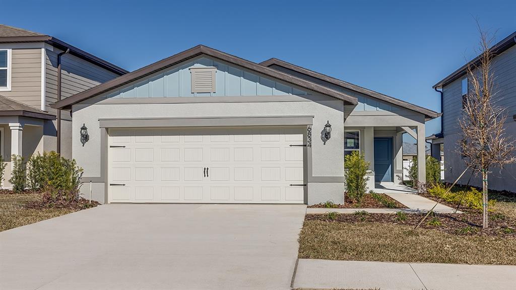 6834 Southwest 90th Loop Ocala, FL 34476 - Photo 1 of 1 a front view of a house with a yard and garage