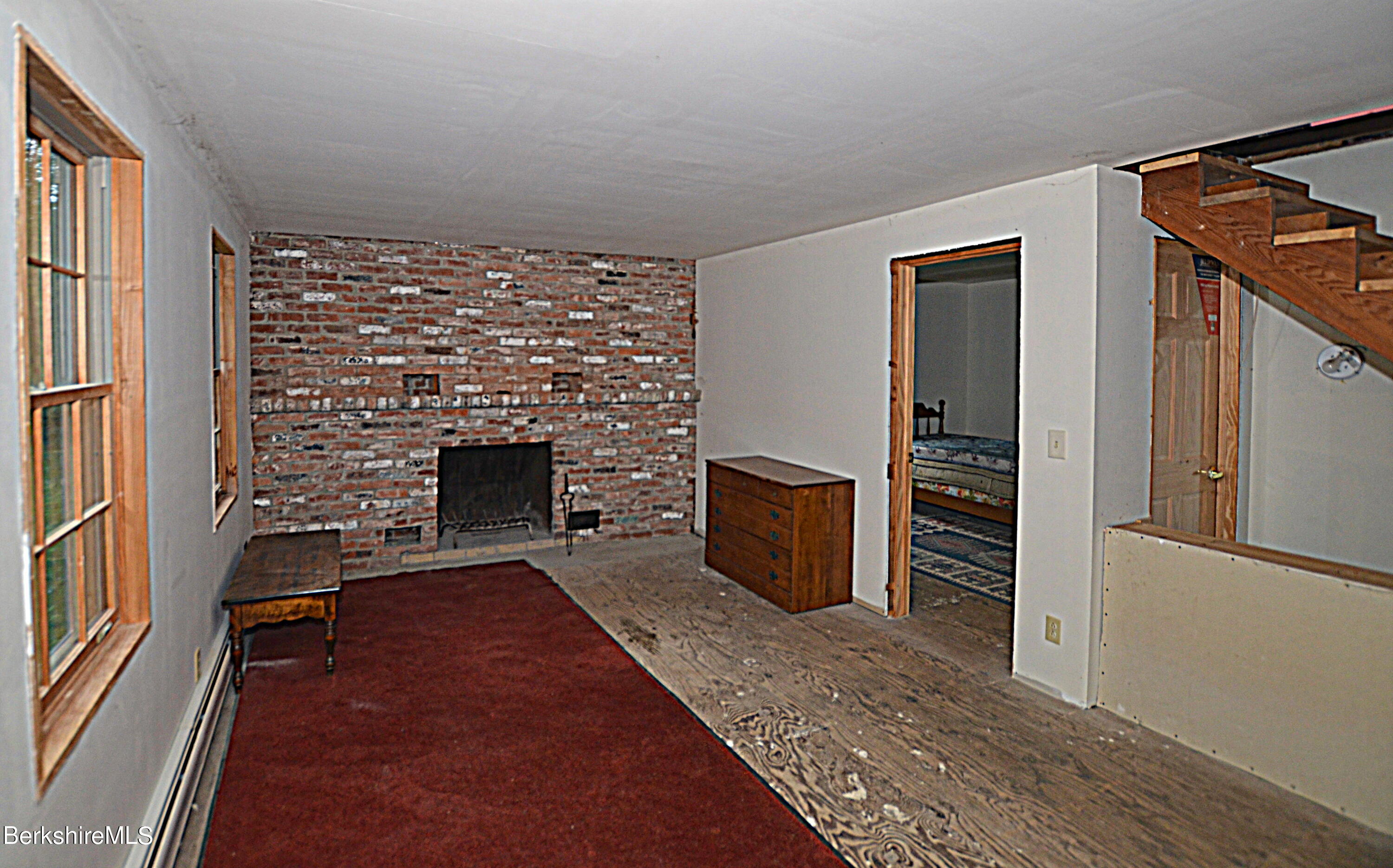 80 Town Hill Road Middlefield, MA 01011 - Photo 11 of 44 a living room with furniture a flat screen tv and a fireplace