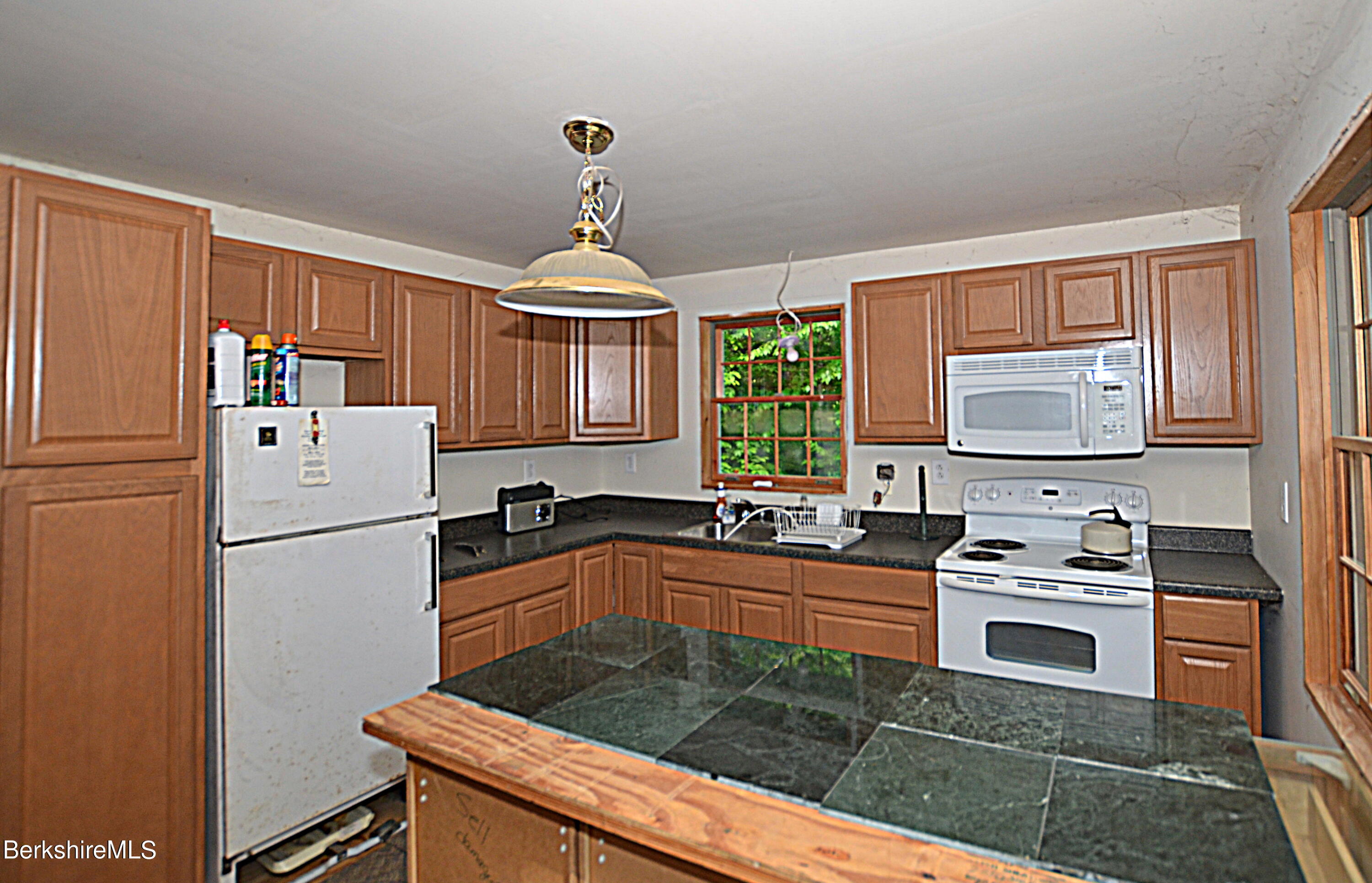 80 Town Hill Road Middlefield, MA 01011 - Photo 14 of 44 a kitchen with granite countertop a sink stainless steel appliances and cabinets