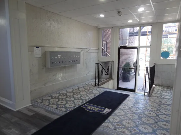 a view of a refrigerator in kitchen and wooden floor