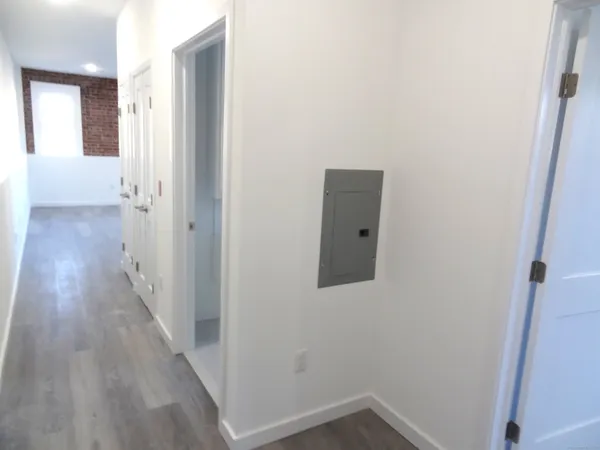 a view of a hallway with wooden floor