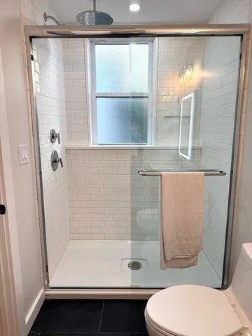 a bathroom with a shower and toilet