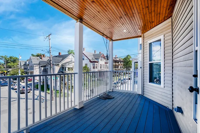 a view of a balcony with wooden floor