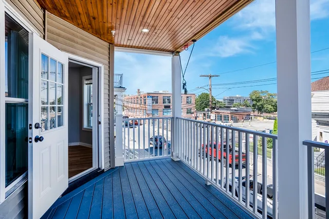 a view of a balcony with wooden floor