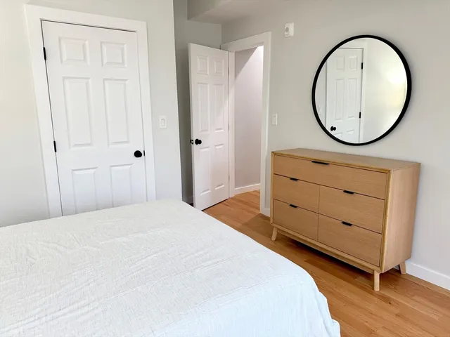 a bedroom with a large bed and a dresser