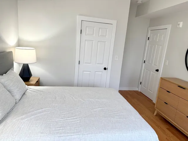 a bedroom with a bed and a lamp