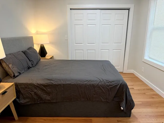 a bedroom with a bed and window