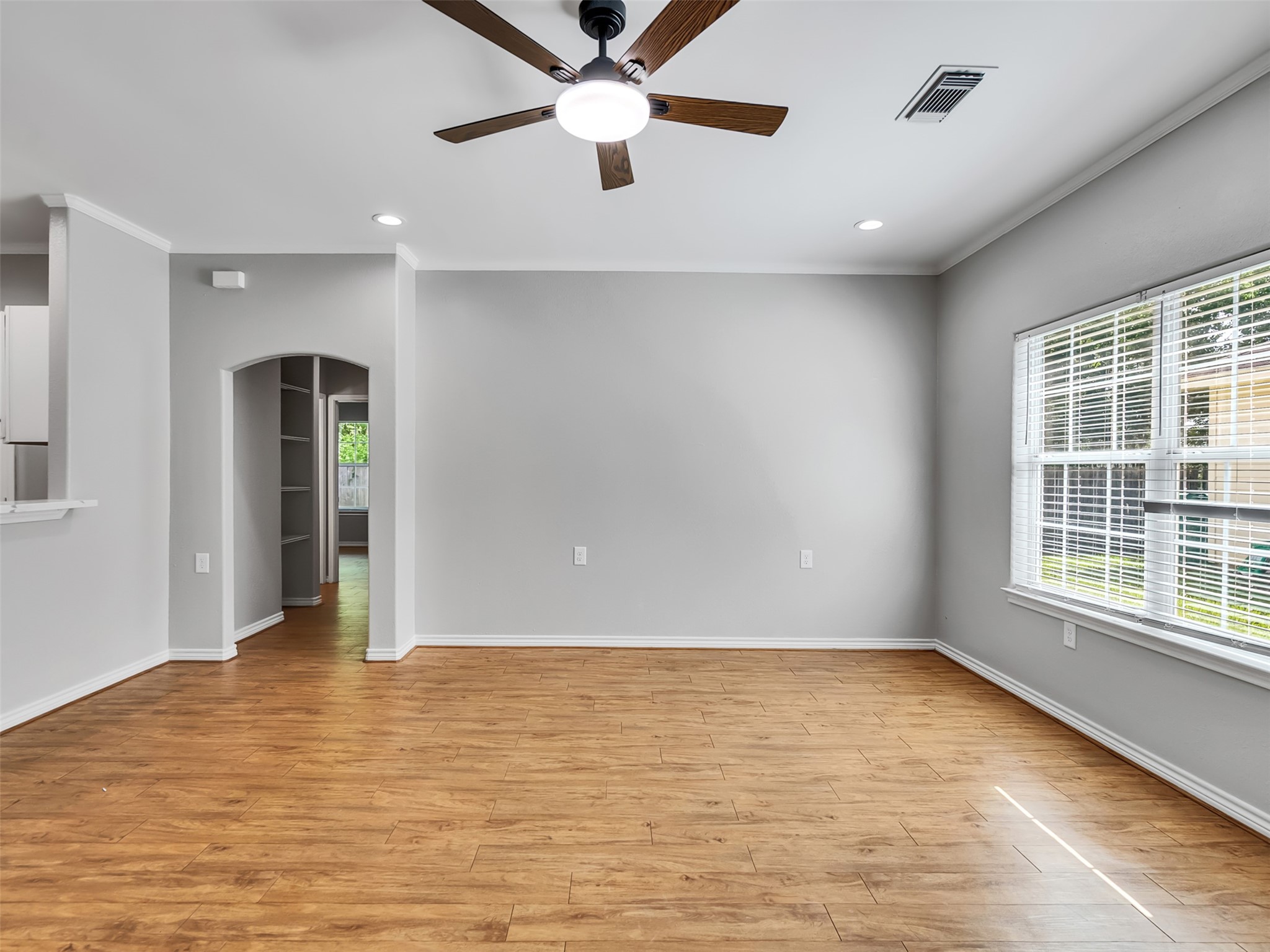 104 Longstreet Road, Unit 2 Willis, TX 77378 - Photo 8 of 26 wooden floor in an empty room with a window