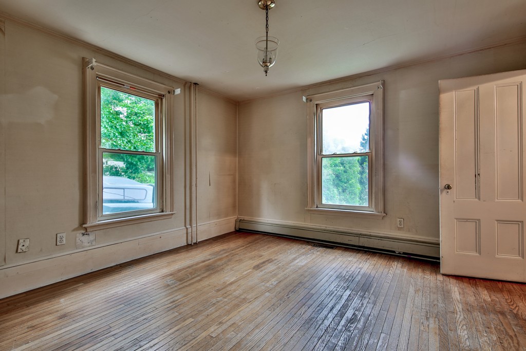 21 Bennett Street Manchester, MA 01944 - Photo 4 of 17 an empty room with wooden floor and windows