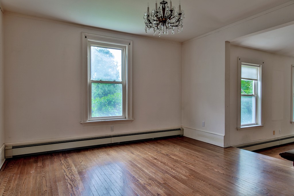 21 Bennett Street Manchester, MA 01944 - Photo 5 of 17 a view of an empty room with wooden floor and a window