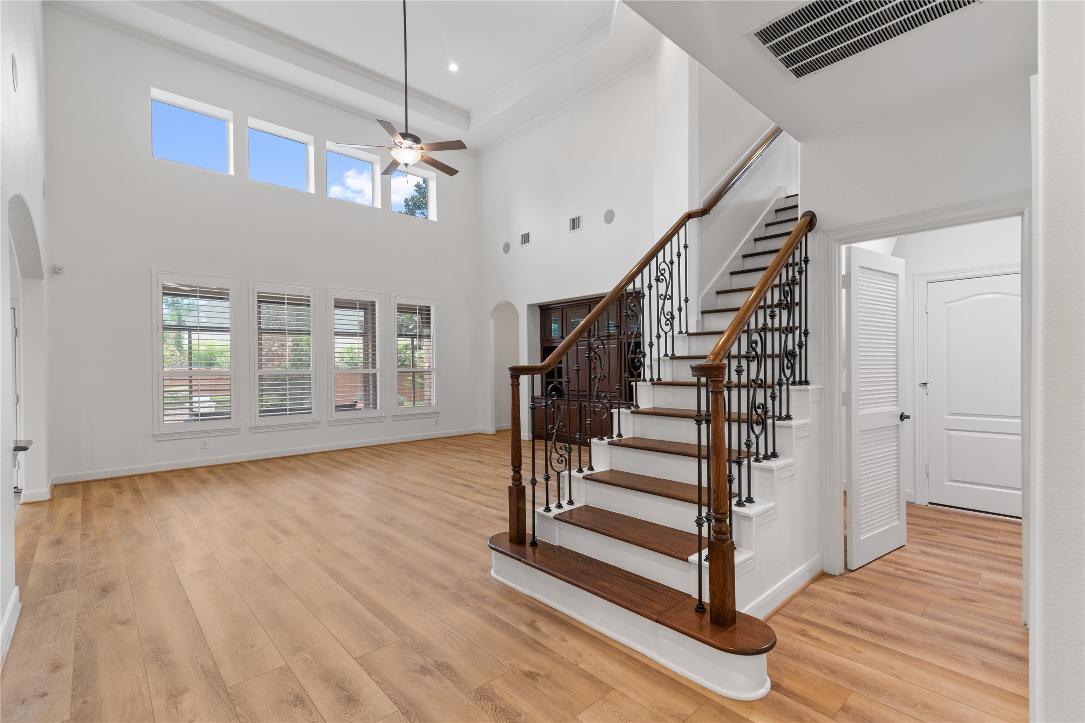 155 South Arrow Canyon Circle Spring, TX 77389 - Photo 15 of 49 Gorgeous details, high ceilings, beautiful railings, wood stairs, a built-in bookcase, plantation shutters, a perfect blend of colors in this amazing property. You will also find the sound-system inside the family room lower cabinet doors.