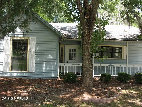 75122 Edwards Road Yulee, FL 32097 - Photo 1 of 8 a view of a brick house with a large windows