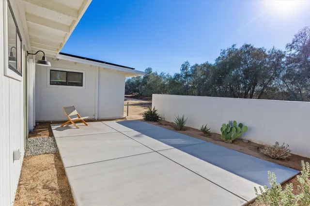 a large kitchen with stainless steel appliances kitchen island a large counter top and a refrigerator