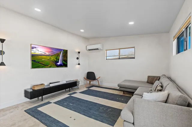 a large kitchen with a large counter top kitchen island a sink stainless steel appliances and cabinets