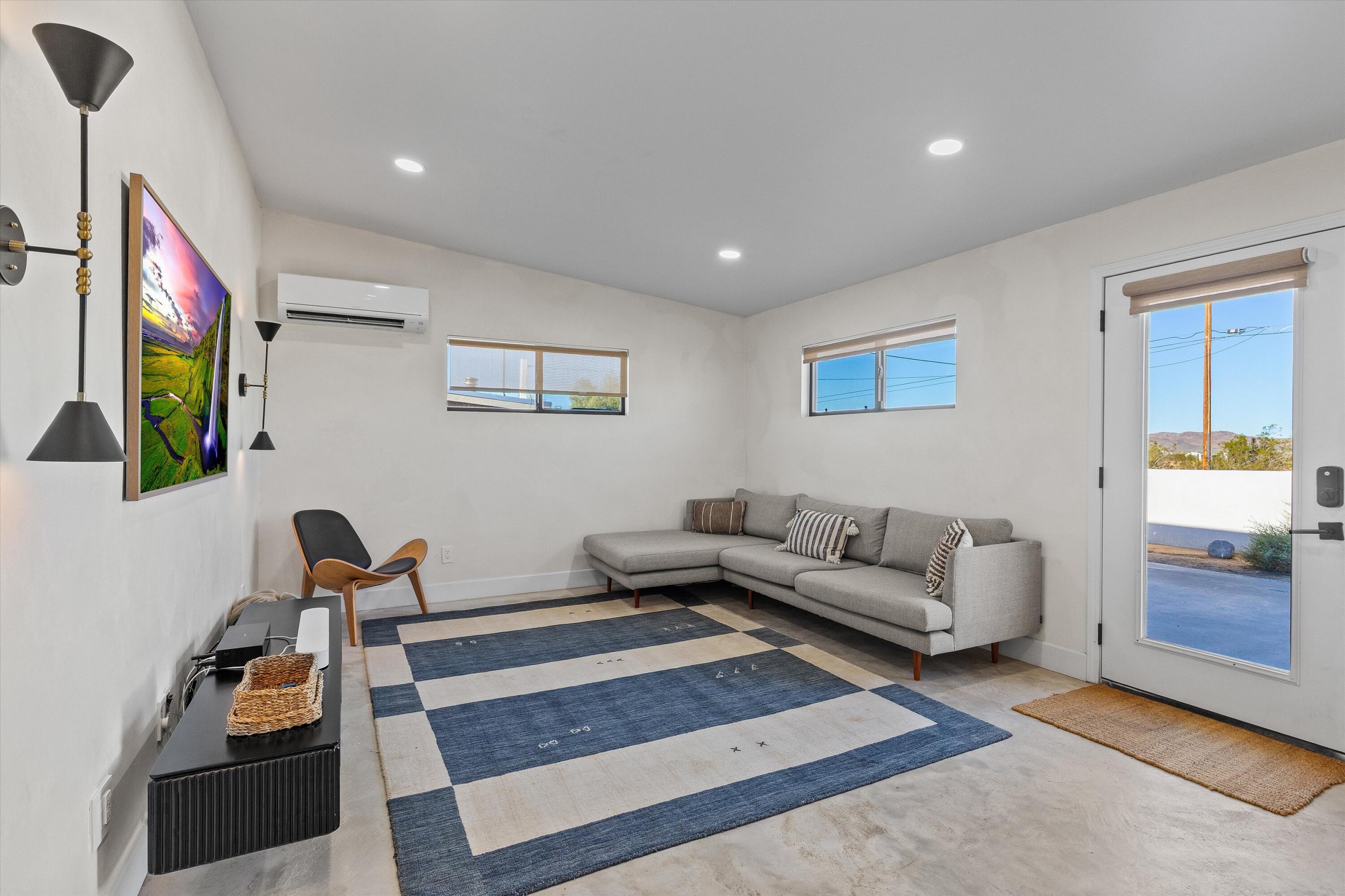 4610 Sunkist Road Joshua Tree, CA 92252 - Photo 14 of 55 a living room with furniture and a flat screen tv